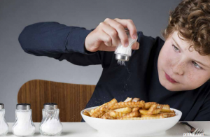 boy adding salt